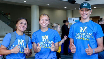 First Year Madonna students holding a thumbs up